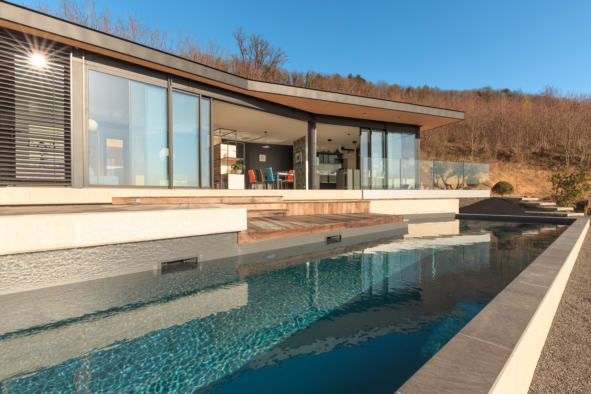 Example of a mid-sized trendy brown one-story wood exterior home design in Lyon