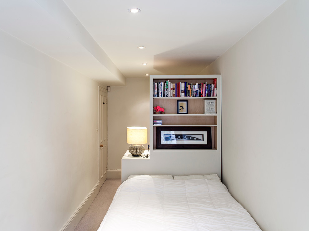 Inspiration for a contemporary bedroom in London with white walls and carpet.