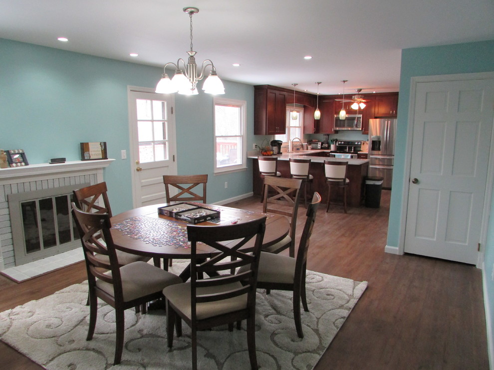 Example of a mid-sized arts and crafts u-shaped vinyl floor home design design with an undermount sink, shaker cabinets, dark wood cabinets, quartz countertops, stainless steel appliances and a peninsula