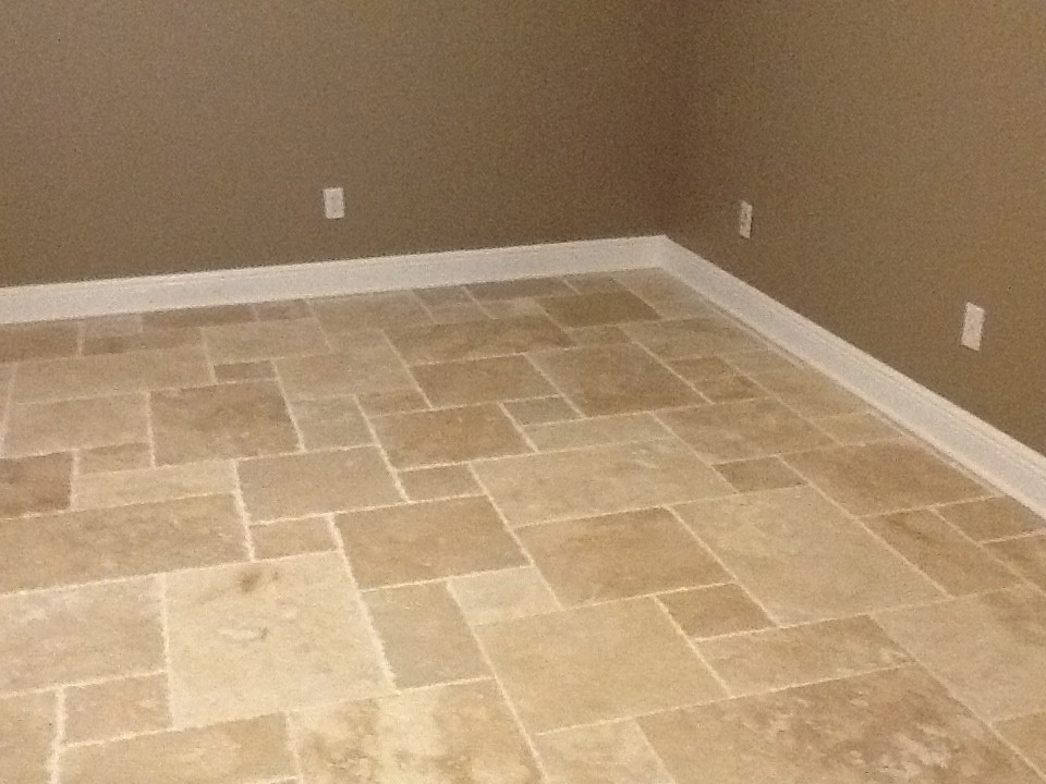 Design ideas for a large transitional guest bedroom in Tampa with beige walls and travertine floors.