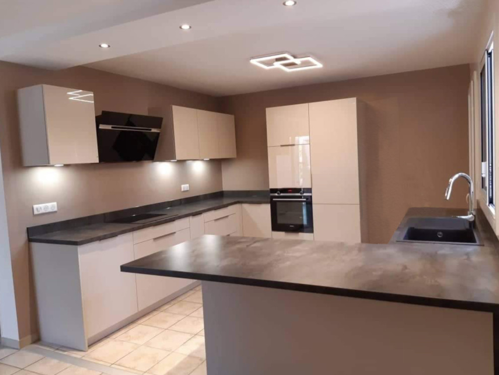 Medium sized modern open plan kitchen in Toulouse with a submerged sink, beaded cabinets, stainless steel cabinets, quartz worktops, brown splashback, glass tiled splashback, stainless steel appliances, ceramic flooring, beige floors and brown worktops.