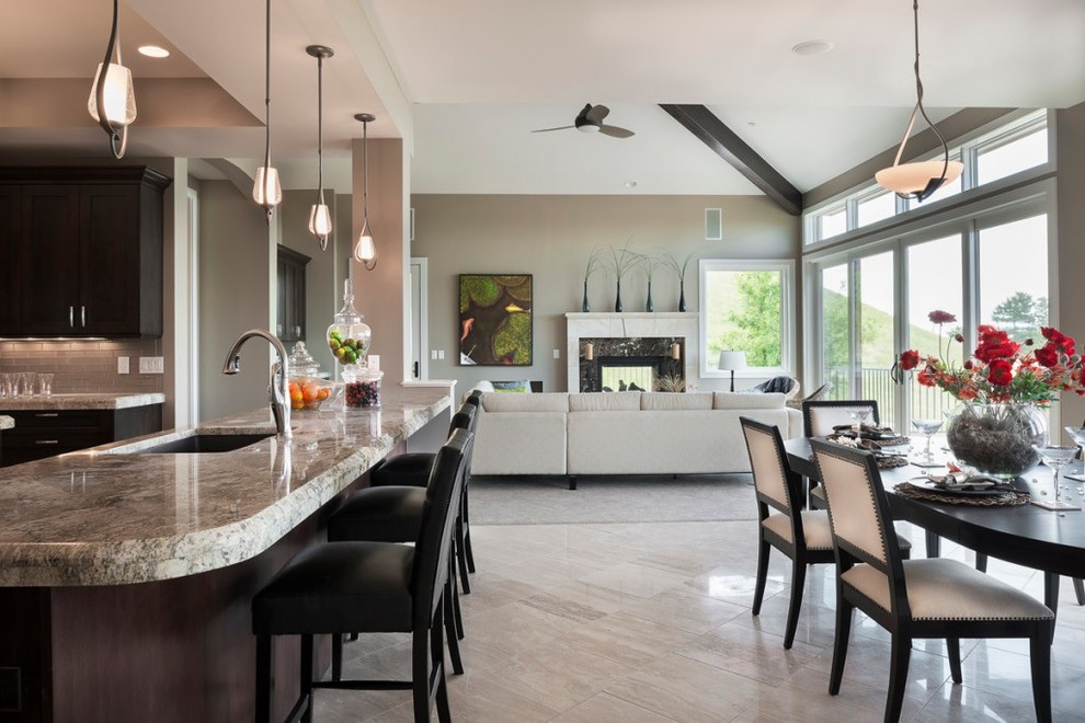 Inspiration for an expansive contemporary kitchen/dining combo in Denver with beige walls, travertine floors, a two-sided fireplace and a tile fireplace surround.