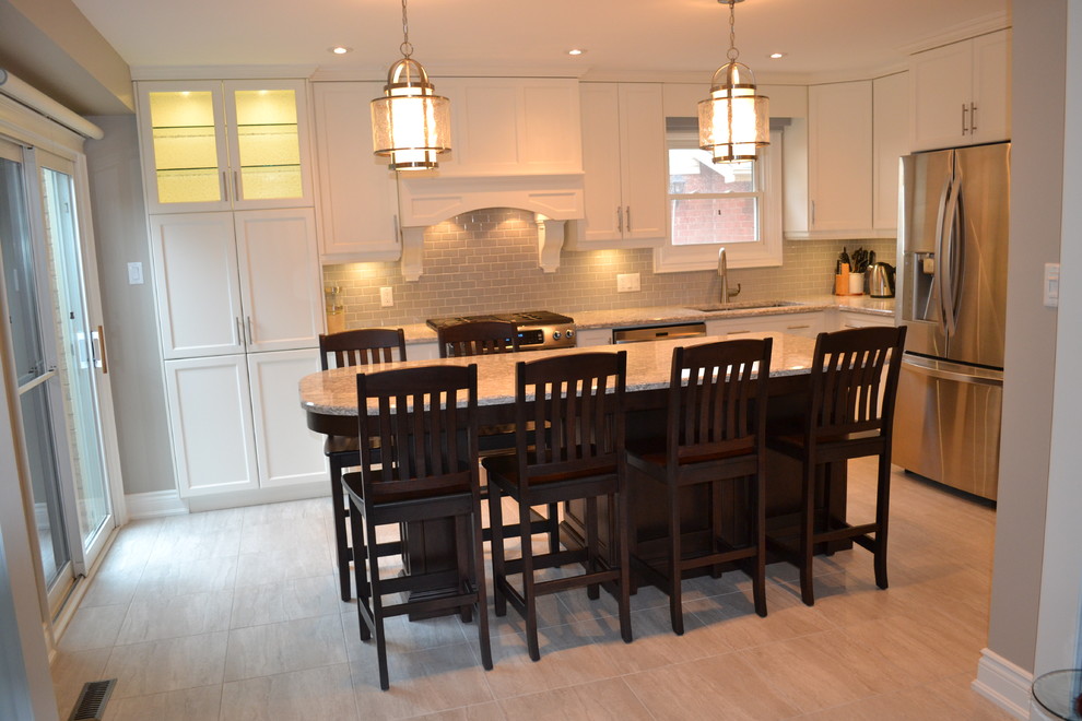 Open concept kitchen - mid-sized transitional single-wall porcelain tile open concept kitchen idea in Toronto with a double-bowl sink, recessed-panel cabinets, white cabinets, quartz countertops, gray backsplash, porcelain backsplash, stainless steel appliances and an island