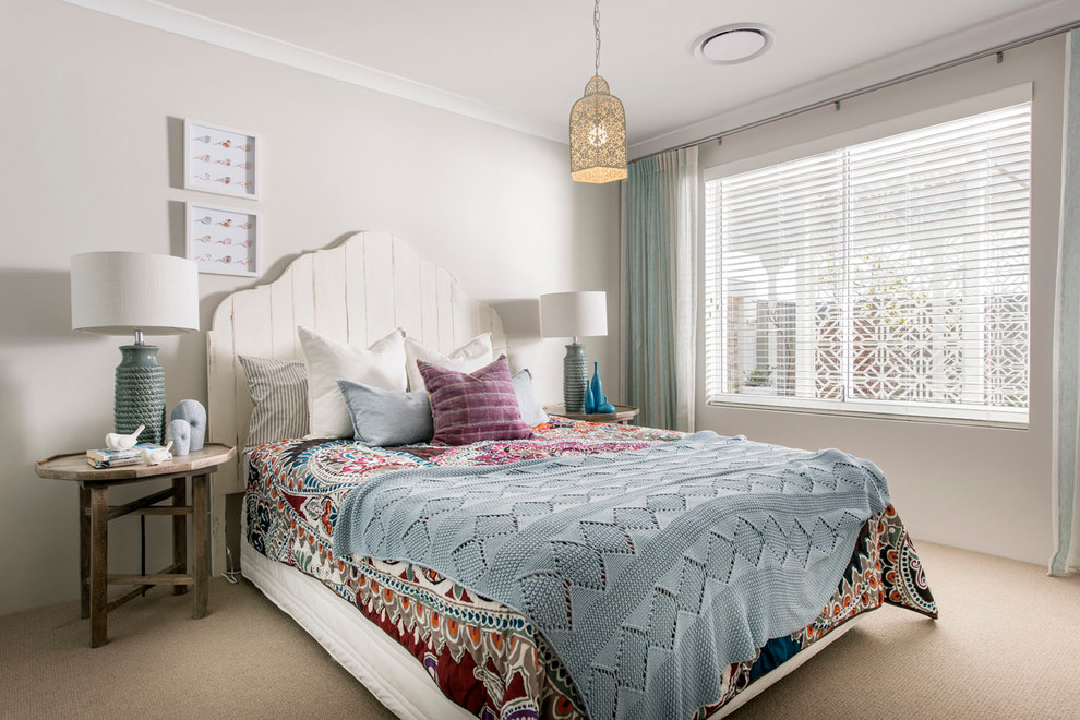 Mid-sized beach style guest bedroom in Perth with beige walls, carpet and no fireplace.
