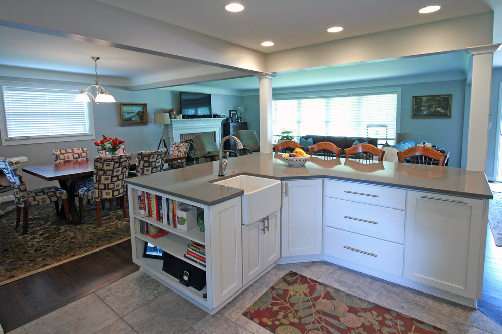 Eat-in kitchen - mid-sized transitional dark wood floor eat-in kitchen idea in Cincinnati with a farmhouse sink, flat-panel cabinets, white cabinets, quartz countertops, multicolored backsplash, ceramic backsplash, stainless steel appliances and an island