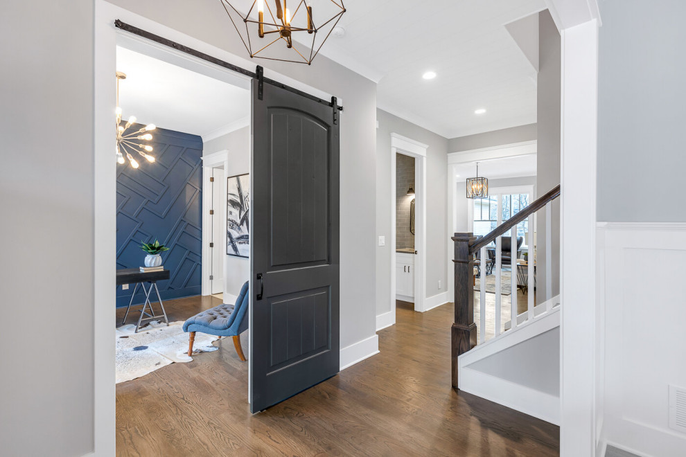 Inspiration for a mid-sized transitional foyer in Atlanta with white walls, light hardwood floors, a single front door, a gray front door and brown floor.