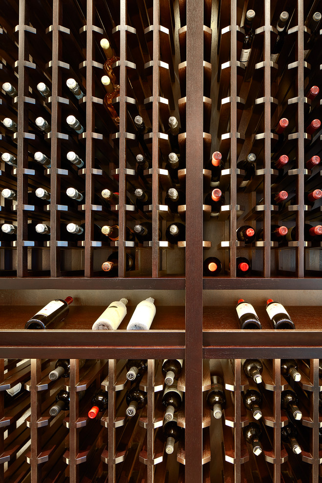 This is an example of a mid-sized transitional wine cellar in Chicago with marble floors, display racks and brown floor.