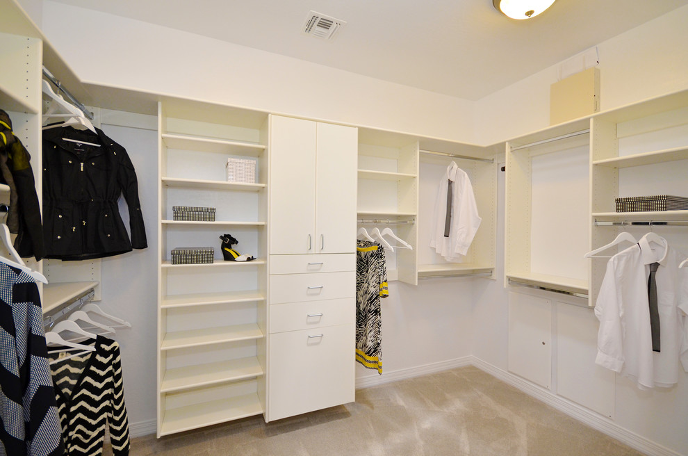 Photo of a mid-sized contemporary gender-neutral walk-in wardrobe in Phoenix with flat-panel cabinets, white cabinets and carpet.