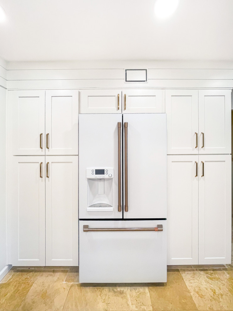 Inspiration for a l-shaped travertine floor kitchen remodel with shaker cabinets