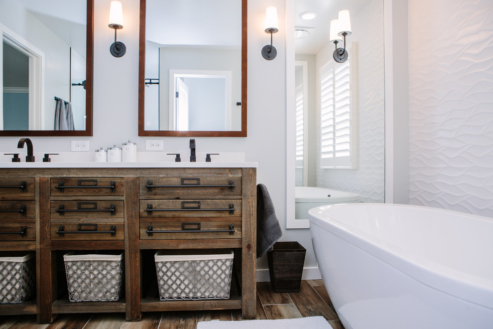 Design ideas for a mid-sized country master bathroom in Denver with distressed cabinets, a freestanding tub, an alcove shower, a one-piece toilet, white tile, ceramic tile, grey walls, porcelain floors, an undermount sink, engineered quartz benchtops, brown floor, a sliding shower screen and flat-panel cabinets.