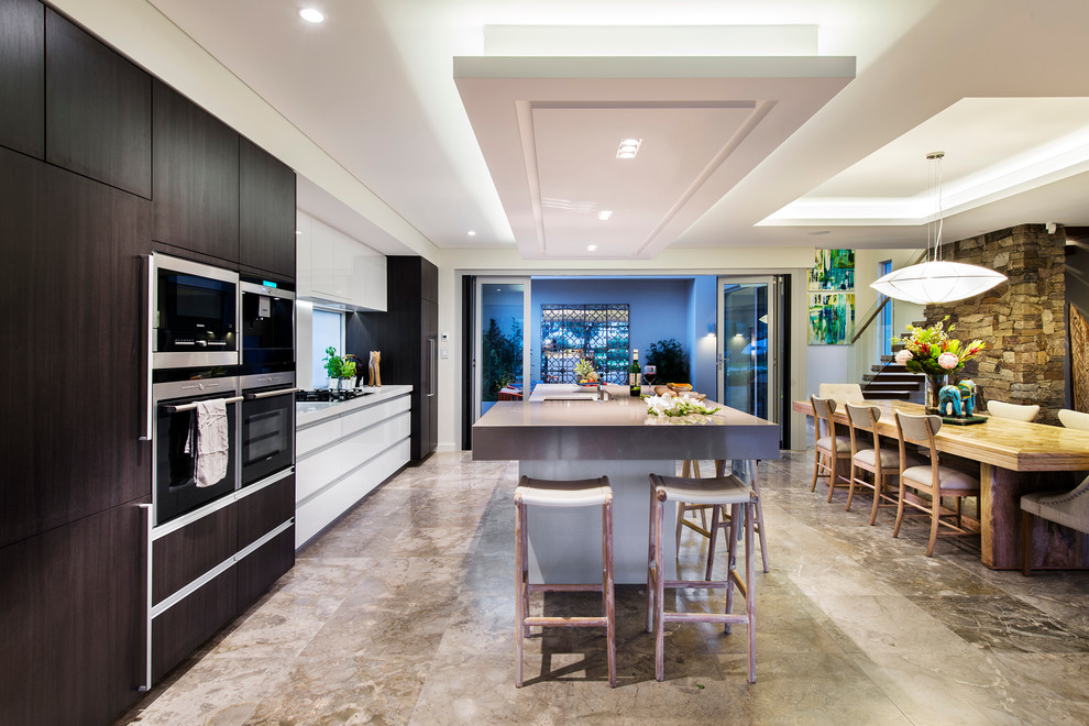 This is an example of a contemporary eat-in kitchen in Perth with marble floors.