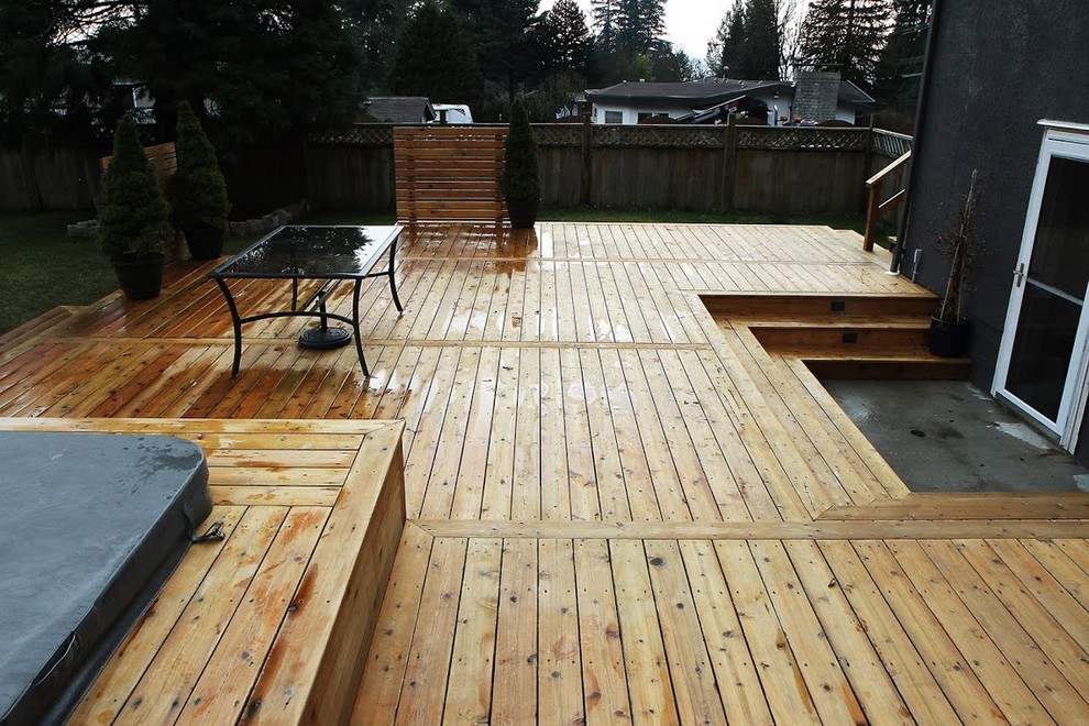 Water fountain deck - large rustic backyard water fountain deck idea in Vancouver with no cover