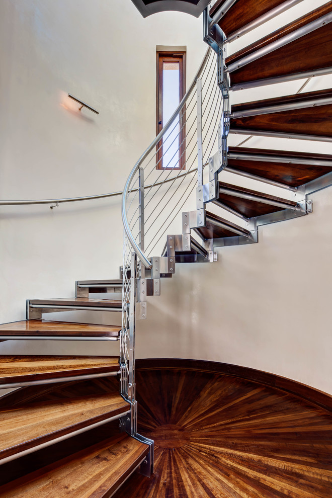 Photo of a wood spiral staircase in Salt Lake City with open risers and cable railing.