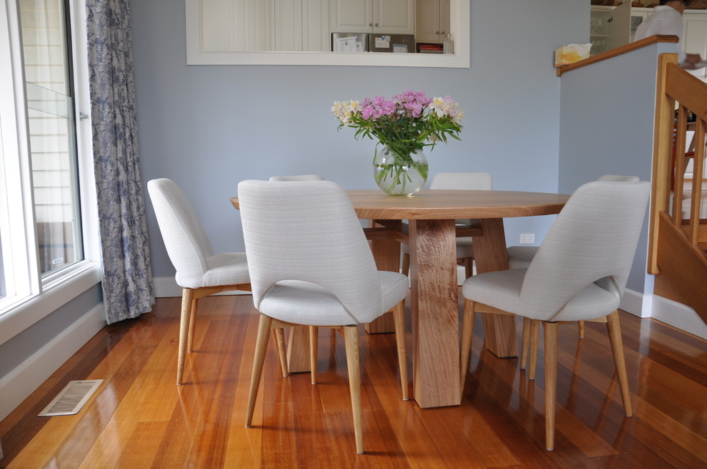 Design ideas for a mid-sized contemporary open plan dining in Melbourne with blue walls, medium hardwood floors and brown floor.