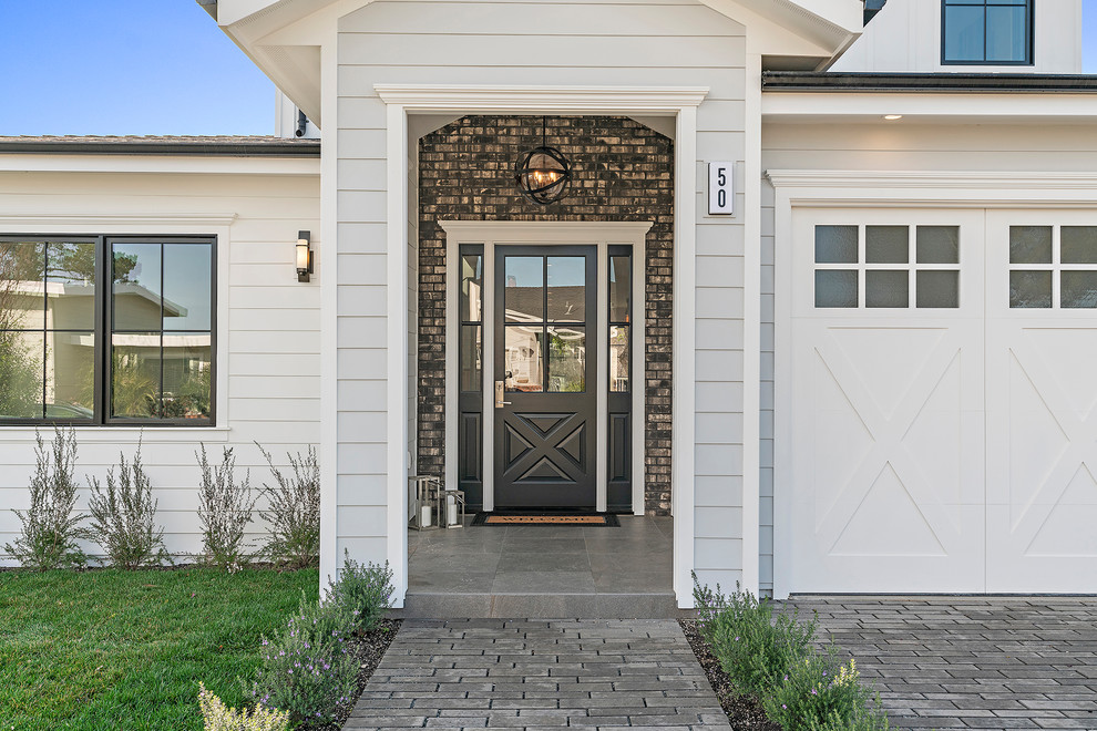 Inspiration for a large transitional two-story wood white and gray floor front door remodel in San Francisco with a shingle roof and a black front door