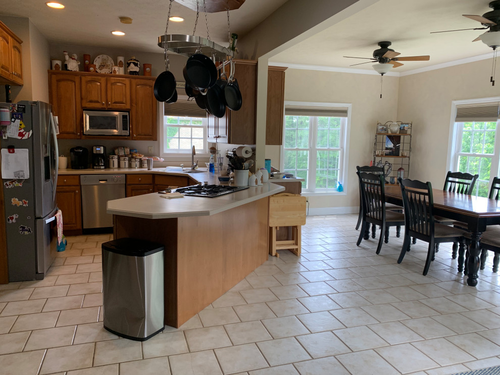 Transitional kitchen photo with flat-panel cabinets, gray cabinets, granite countertops, gray backsplash, porcelain backsplash and an island