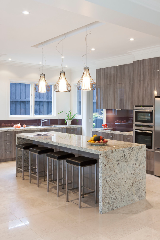 Photo of a large contemporary open plan kitchen in Melbourne with an undermount sink, flat-panel cabinets, medium wood cabinets, granite benchtops, glass sheet splashback, stainless steel appliances, porcelain floors and with island.