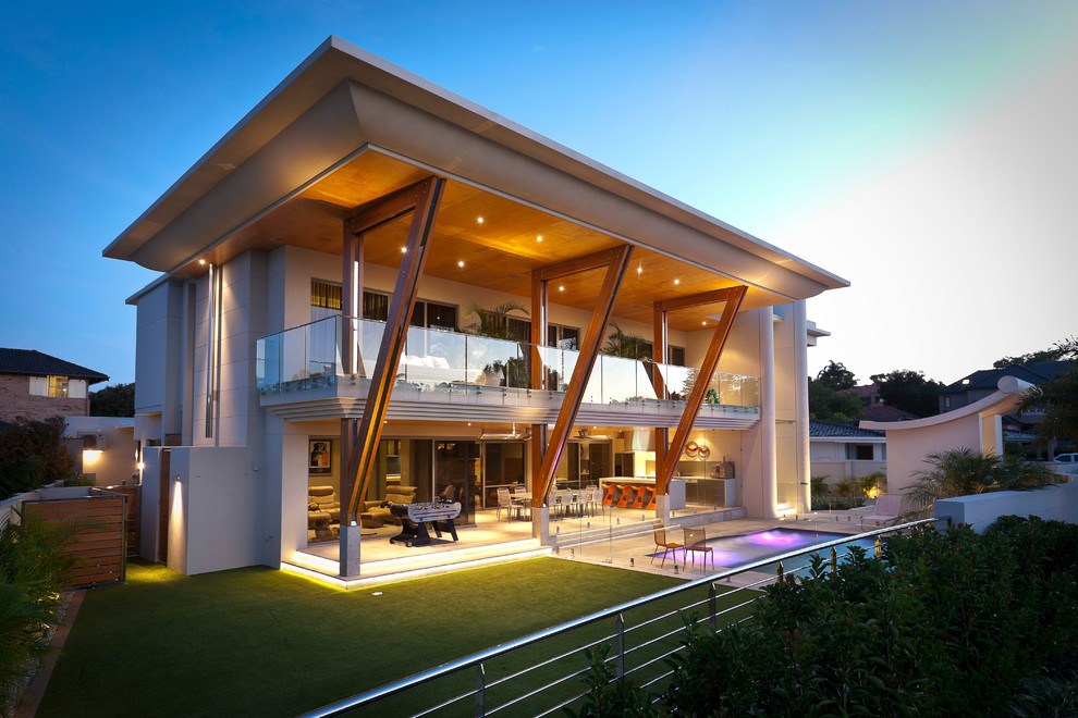 This is an example of an expansive contemporary two-storey beige exterior in Perth with a flat roof.