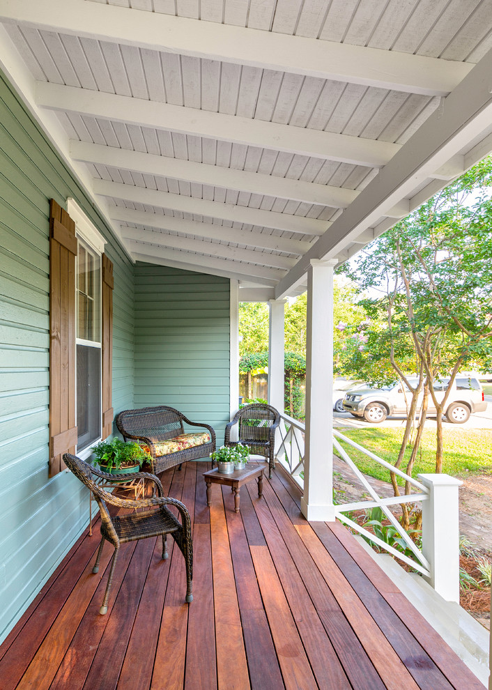 Large classic front porch idea in Miami with decking and a roof extension