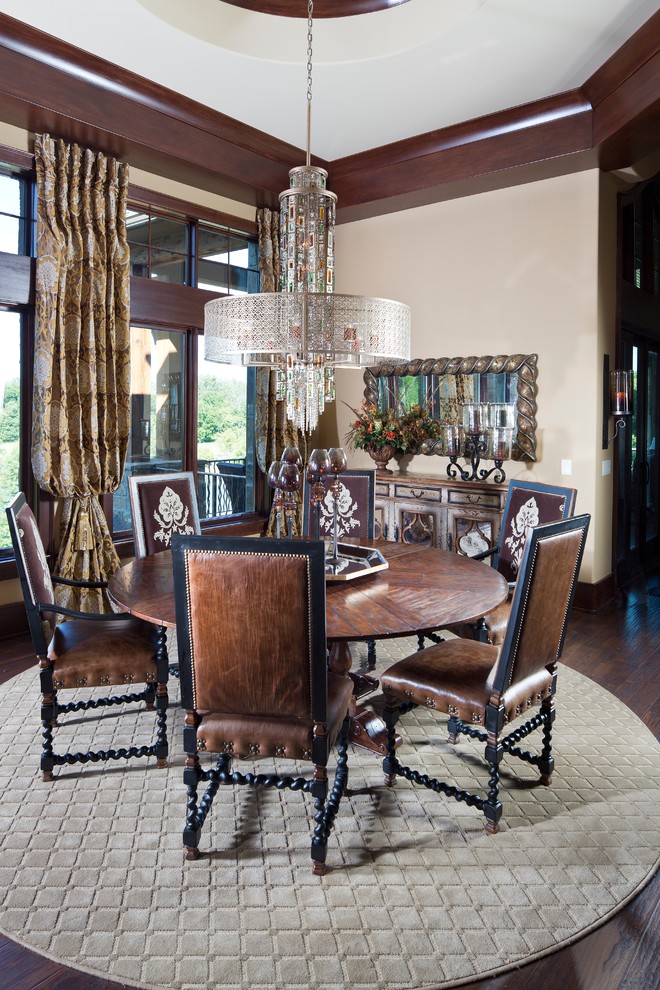 This is an example of a mediterranean dining room in Indianapolis with beige walls and dark hardwood floors.