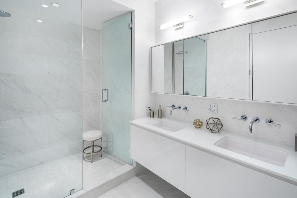 Design ideas for a mid-sized contemporary master bathroom in New York with white cabinets, white tile, marble, white walls, marble floors, marble benchtops, white benchtops, a double vanity, a floating vanity and flat-panel cabinets.