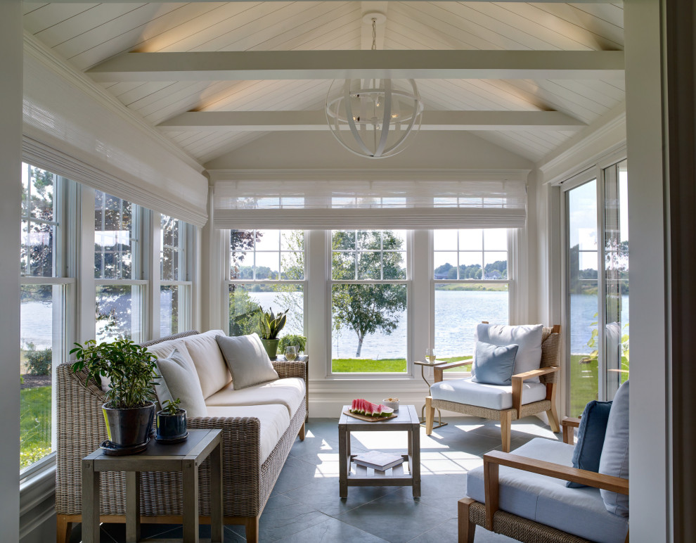 Design ideas for a beach style sunroom in Portland Maine with a standard ceiling and grey floor.