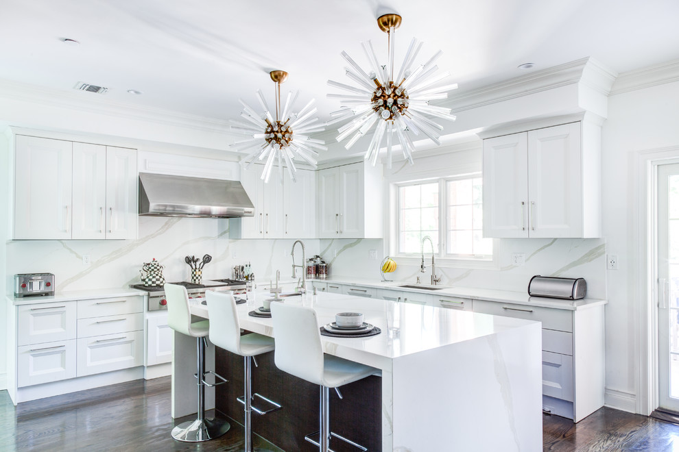 Example of a large transitional u-shaped dark wood floor and brown floor open concept kitchen design in New York with white cabinets, quartzite countertops, white backsplash, stone slab backsplash, stainless steel appliances, an island and recessed-panel cabinets