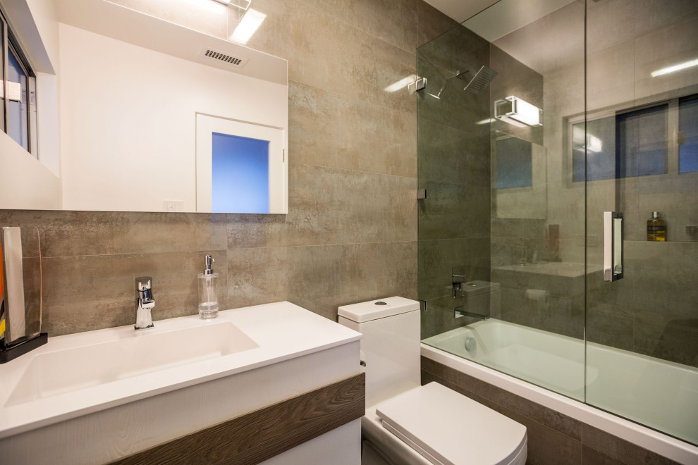 Cette photo montre une salle d'eau moderne avec une baignoire en alcôve, un combiné douche/baignoire et une cabine de douche à porte battante.