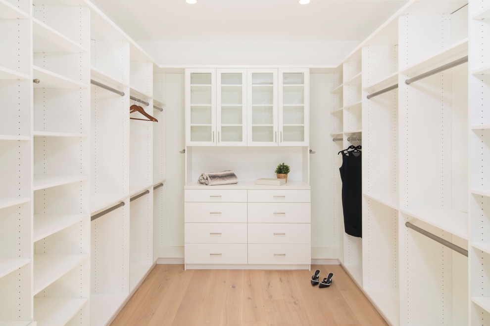 Photo of a contemporary storage and wardrobe in San Francisco with flat-panel cabinets and white cabinets.