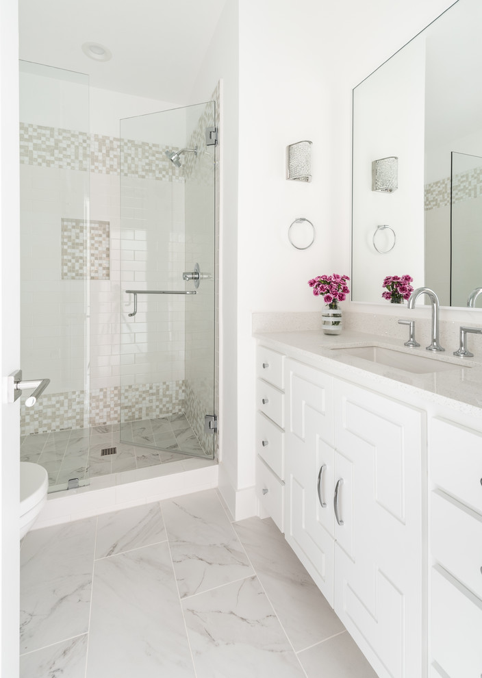 Photo of a mid-sized transitional 3/4 bathroom in Dallas with flat-panel cabinets, white cabinets, an alcove shower, white walls, ceramic floors, an undermount sink, engineered quartz benchtops, white floor, a hinged shower door, white benchtops, beige tile, white tile and subway tile.