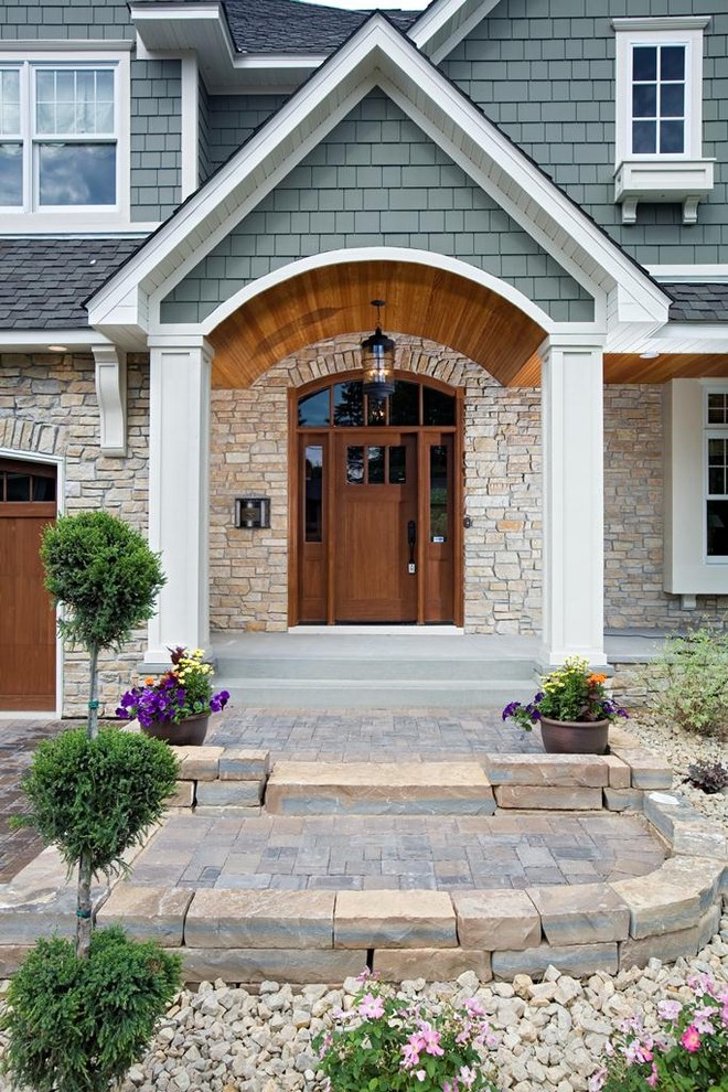 Design ideas for a traditional entryway in Minneapolis with a medium wood front door.