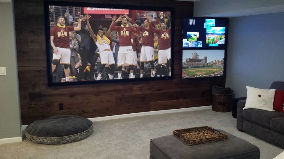 This is an example of a modern home theatre in Cleveland with a wall-mounted tv.