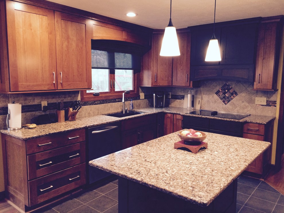 Photo of a mid-sized arts and crafts u-shaped eat-in kitchen in Indianapolis with an undermount sink, recessed-panel cabinets, medium wood cabinets, quartz benchtops, metallic splashback, ceramic splashback, stainless steel appliances, ceramic floors and with island.