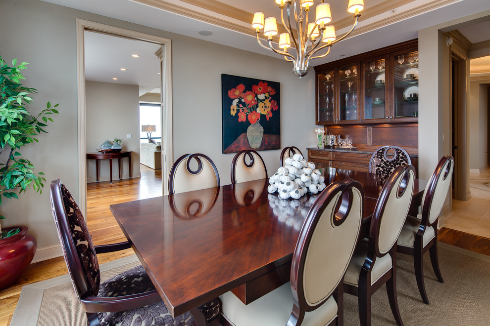 This is an example of a traditional separate dining room in Minneapolis with grey walls and medium hardwood floors.