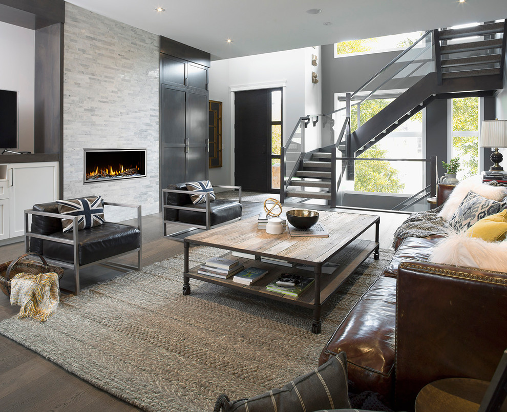 Inspiration for a mid-sized modern open concept living room in Boston with grey walls, medium hardwood floors, a ribbon fireplace, a stone fireplace surround, a freestanding tv and brown floor.