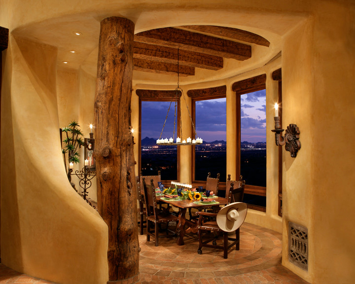This is an example of a dining room in Phoenix with terra-cotta floors.