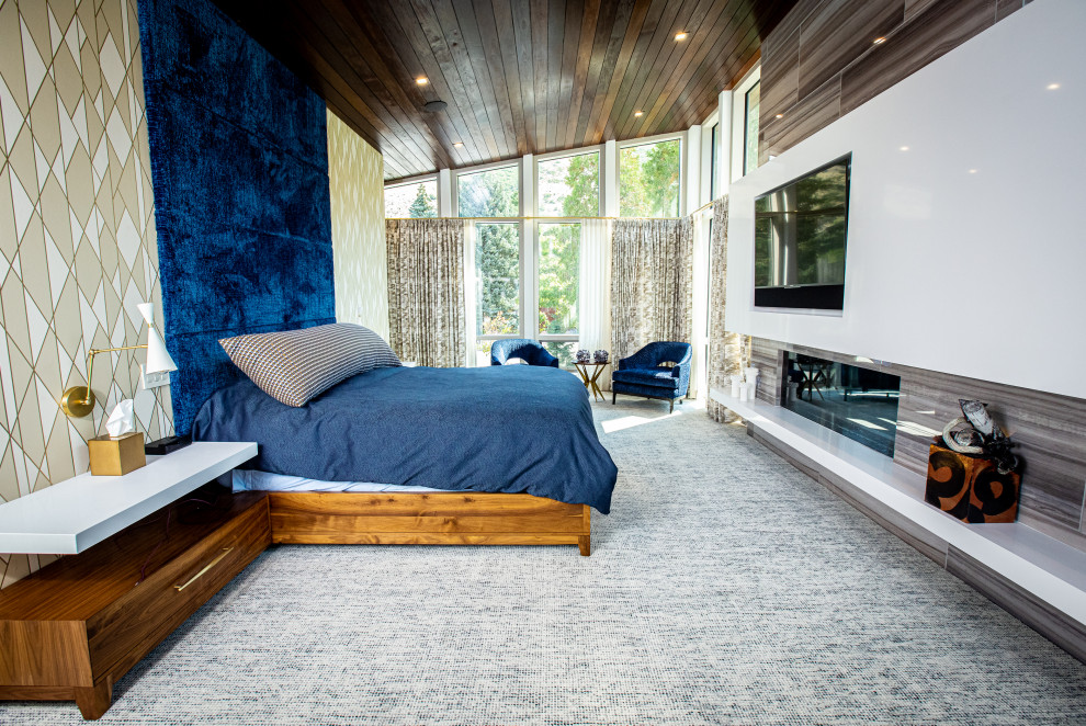 Photo of an expansive midcentury master bedroom in Salt Lake City with multi-coloured walls, carpet, a ribbon fireplace, a stone fireplace surround, grey floor, vaulted, wood and wallpaper.