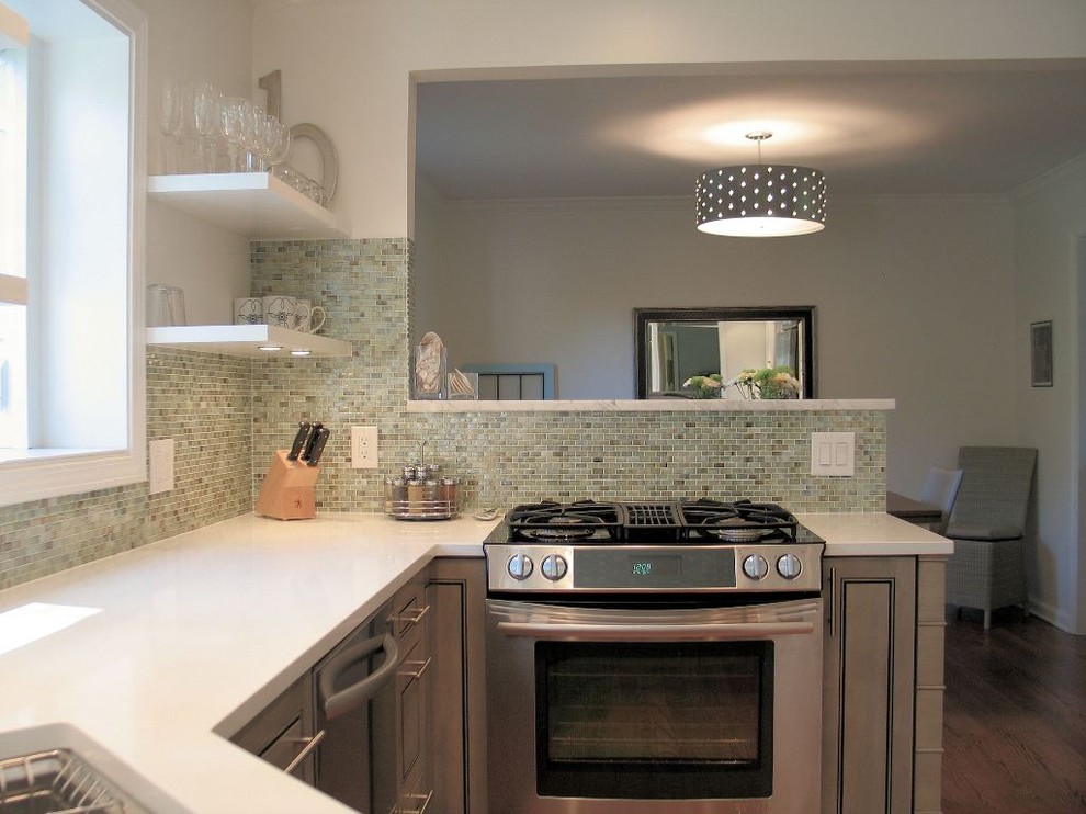 This is an example of a contemporary eat-in kitchen in Indianapolis with stainless steel appliances, green splashback, mosaic tile splashback and grey cabinets.