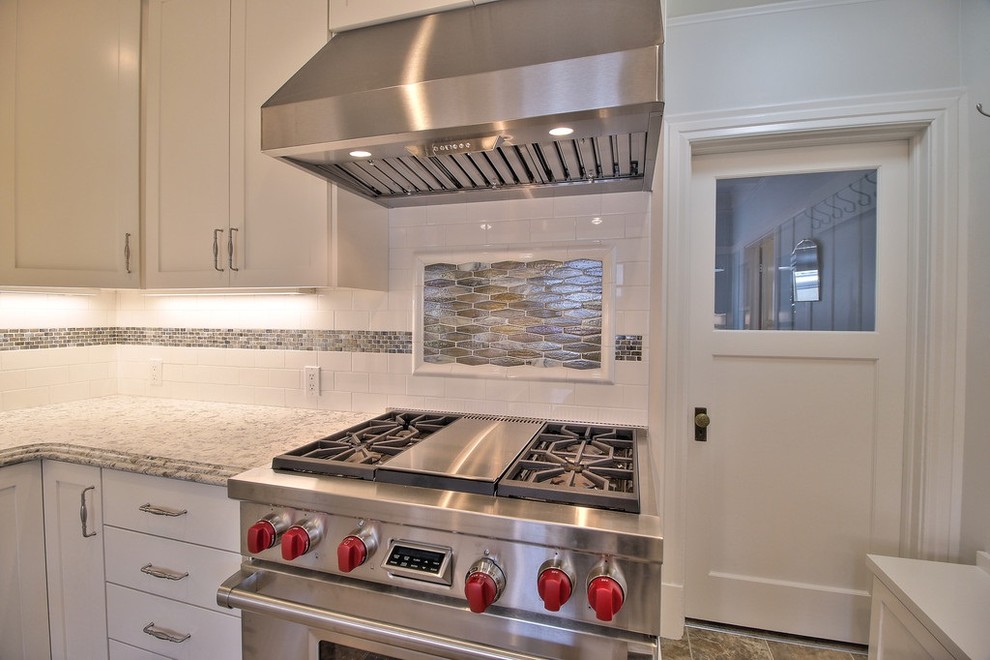Inspiration for a small transitional galley eat-in kitchen in San Francisco with an undermount sink, shaker cabinets, white cabinets, quartzite benchtops, white splashback, glass tile splashback, stainless steel appliances and vinyl floors.