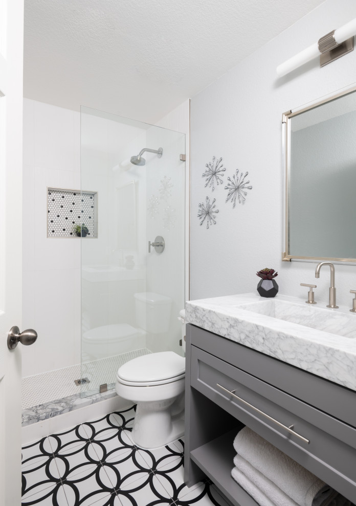 Inspiration for a transitional bathroom in Austin with shaker cabinets, grey cabinets, an alcove shower, white tile, white walls, an integrated sink, multi-coloured floor, an open shower, white benchtops, a single vanity and a freestanding vanity.