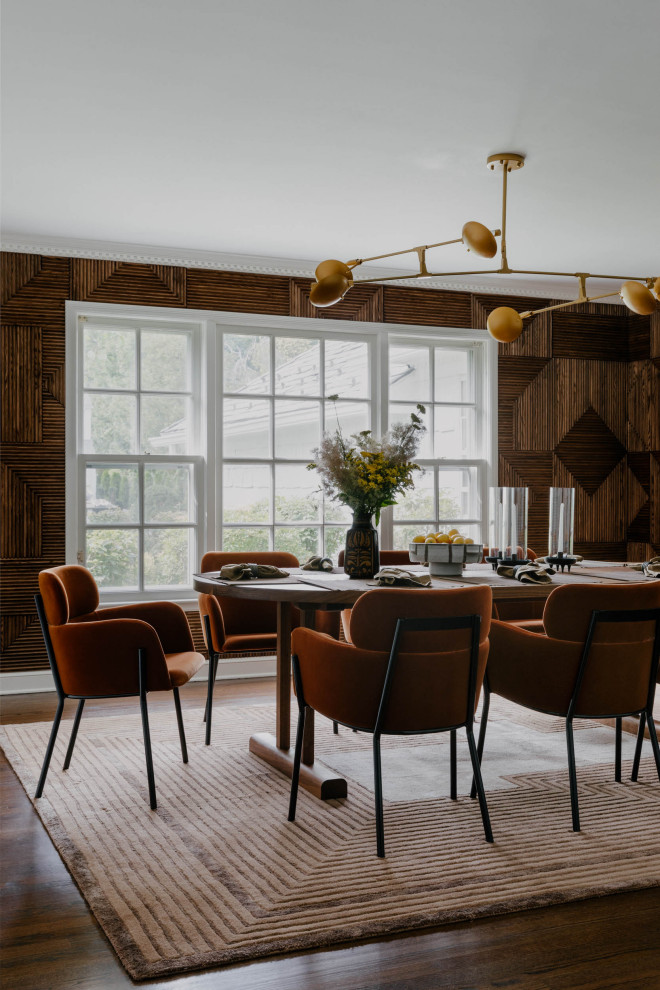 Mid-sized midcentury separate dining room in New York with brown walls, medium hardwood floors, brown floor and wood walls.
