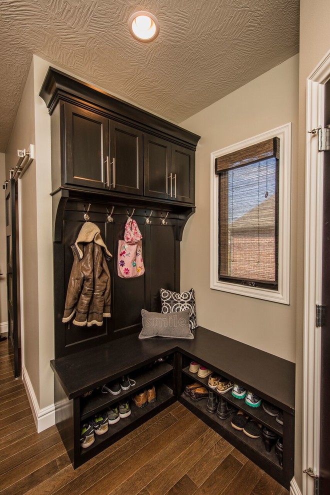 Mid-sized transitional dark wood floor mudroom photo with beige walls