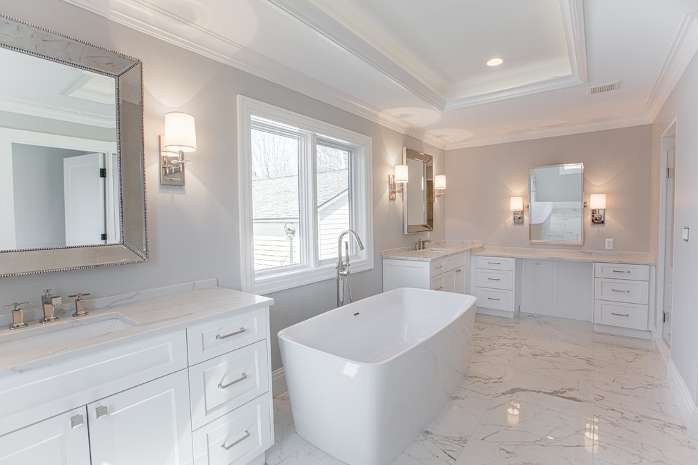 Country master bathroom in Detroit with white cabinets and grey walls.