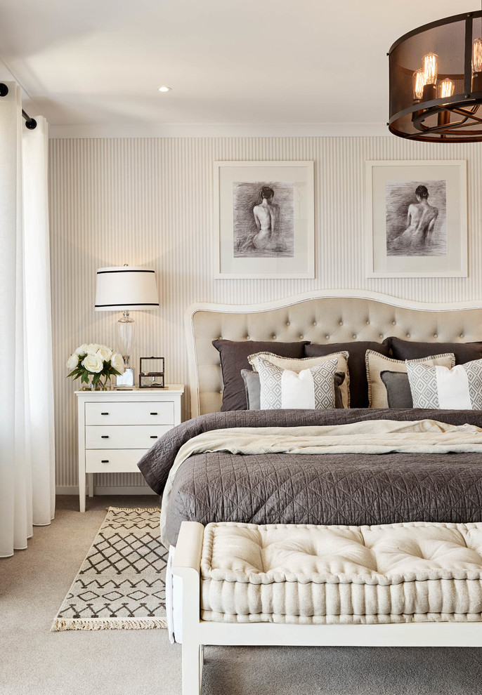 Photo of a traditional master bedroom in Melbourne with beige walls and carpet.
