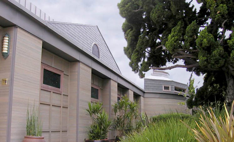 Large minimalist beige two-story mixed siding flat roof photo in San Diego