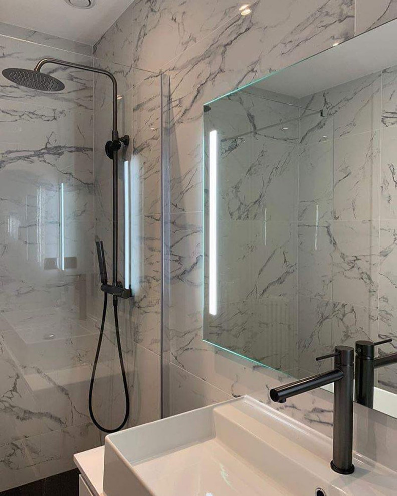 Idéer för mellanstora funkis badrum med dusch, med vita skåp, en kantlös dusch, vit kakel, marmorkakel, vita väggar, cementgolv, ett konsol handfat och svart golv