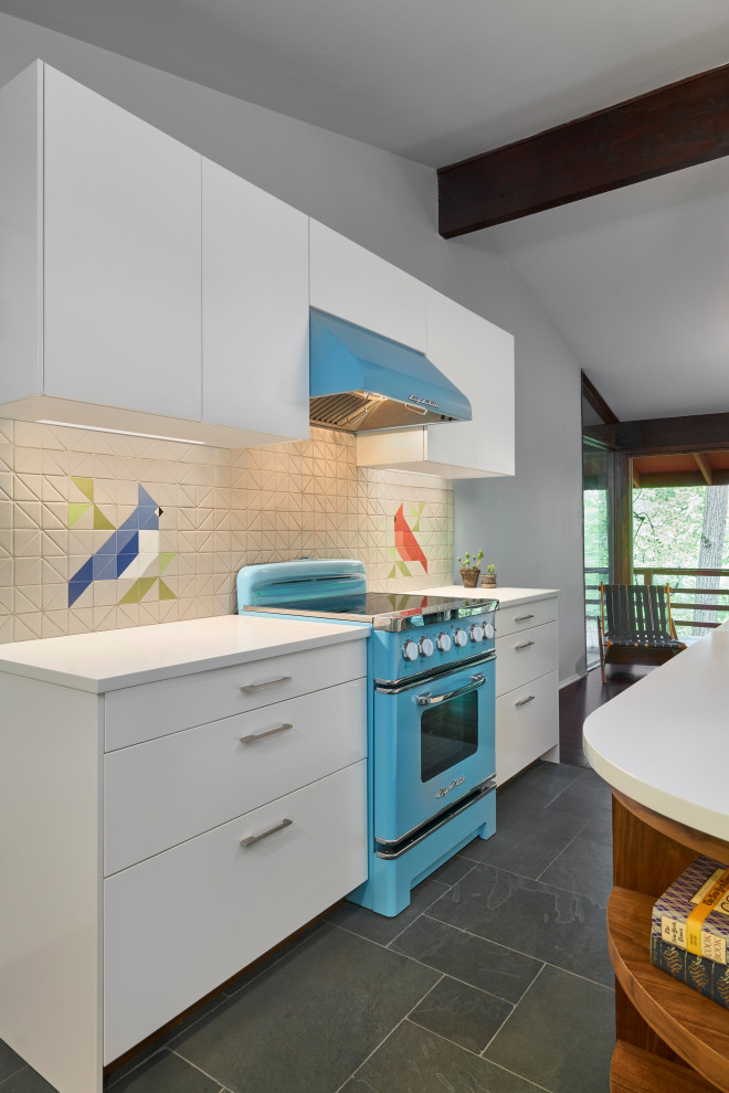 Inspiration for a midcentury kitchen in Philadelphia with an undermount sink, flat-panel cabinets, brown cabinets, quartz benchtops, multi-coloured splashback, ceramic splashback, coloured appliances, slate floors, with island, grey floor, white benchtop and exposed beam.