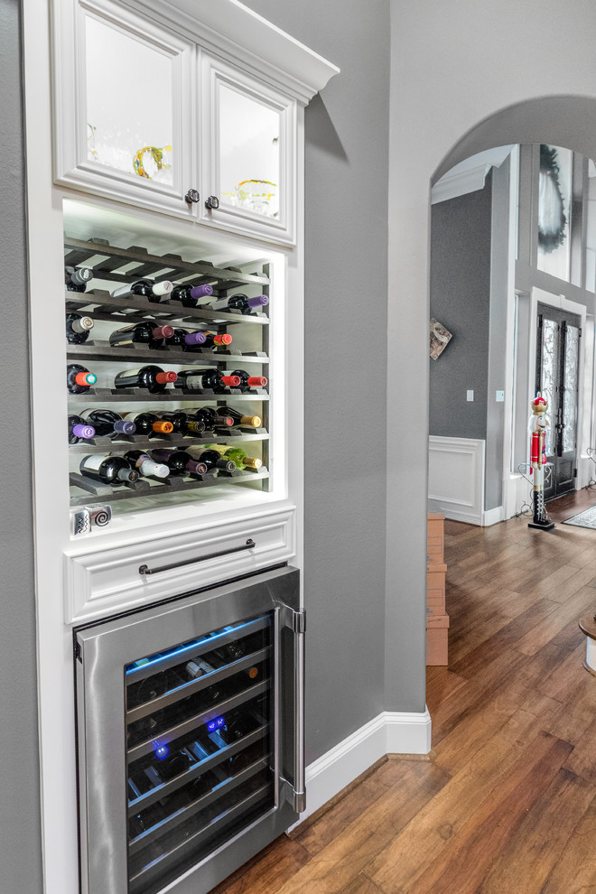 Kitchen pantry - large transitional u-shaped dark wood floor and brown floor kitchen pantry idea in Houston with a farmhouse sink, raised-panel cabinets, gray cabinets, quartzite countertops, gray backsplash, limestone backsplash, stainless steel appliances, a peninsula and gray countertops