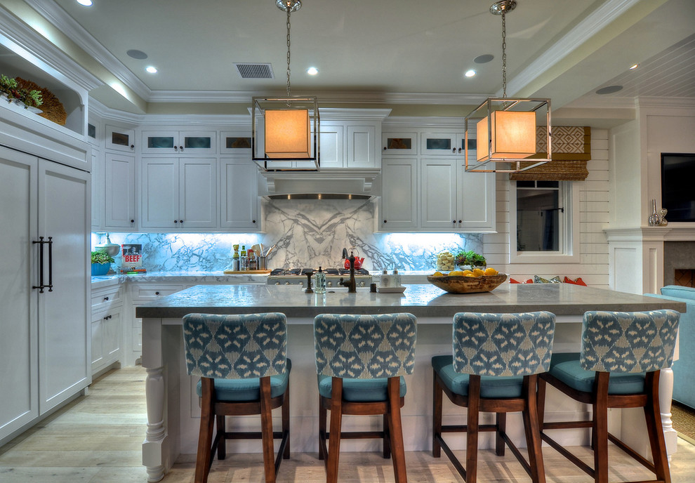 This is an example of a traditional kitchen in Orange County with white cabinets and panelled appliances.
