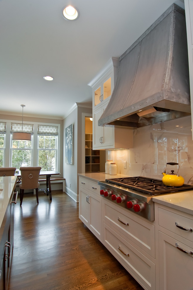 Photo of a transitional kitchen in Minneapolis with recessed-panel cabinets, white cabinets and white splashback.